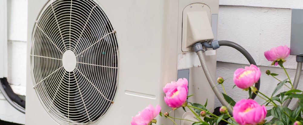 Photograph of an air source heat pumped fixed to the outside of a building.